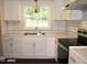 Bright kitchen features white cabinets, subway tile backsplash, and stainless steel appliances at 10180 Buffalo Rd, Clayton, NC 27527