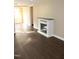 Cozy living room featuring hardwood floors, neutral paint and modern electric fireplace at 10180 Buffalo Rd, Clayton, NC 27527