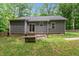 A backyard with a fenced perimeter and a wood exterior of the home at 1027 Holden Rd, Youngsville, NC 27596