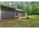 A backyard with a fenced perimeter, storage shed, and a wood exterior of the home at 1027 Holden Rd, Youngsville, NC 27596