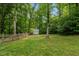 This property features a storage shed with a white exterior and backyard perimeter fence at 1027 Holden Rd, Youngsville, NC 27596