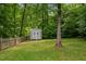 This property features a storage shed with a white exterior and backyard perimeter fence at 1027 Holden Rd, Youngsville, NC 27596