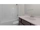 A full bathroom with a shower and tub combo and dark wood cabinets at 1027 Holden Rd, Youngsville, NC 27596