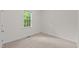 A cozy bedroom with carpet flooring and a window overlooking the backyard at 1027 Holden Rd, Youngsville, NC 27596