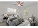 Well-lit bedroom with neutral tones, cozy carpet, ceiling fan, and great natural light at 1027 Holden Rd, Youngsville, NC 27596