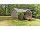 View of the rear of the house showing the wooden porch and stairs, and wooden fence at 1027 Holden Rd, Youngsville, NC 27596