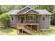 Charming exterior of the home with a quaint porch and gray shake siding at 1027 Holden Rd, Youngsville, NC 27596