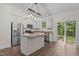 Kitchen with stainless steel appliances, granite countertops, and a sliding glass door to the backyard at 1027 Holden Rd, Youngsville, NC 27596