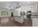 Open-concept kitchen with stainless steel appliances, island, and seamless connection to living area at 1027 Holden Rd, Youngsville, NC 27596