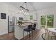 Bright kitchen featuring an island with bar seating and stainless steel appliances at 1027 Holden Rd, Youngsville, NC 27596