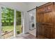 Convenient laundry area with stacked washer and dryer, backyard access and an appealing barn door at 1027 Holden Rd, Youngsville, NC 27596