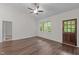 Open living room featuring ceiling fan, wood floors, and large windows that provide natural light at 1027 Holden Rd, Youngsville, NC 27596