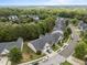 An aerial shot showcases a neighborhood's neatly arranged townhomes surrounded by mature trees at 10404 Dapping Dr, Raleigh, NC 27614