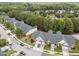 An aerial view of townhomes showcases the neighborhood's lush greenery and well-kept exteriors at 10404 Dapping Dr, Raleigh, NC 27614
