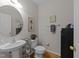 Cozy powder room featuring modern fixtures, stylish decor and a circular mirror at 10404 Dapping Dr, Raleigh, NC 27614