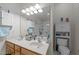 Bright bathroom featuring a glass enclosed shower, white cabinets, and double sinks at 10404 Dapping Dr, Raleigh, NC 27614