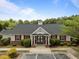 Community clubhouse with red shutters and a well-manicured lawn at 10404 Dapping Dr, Raleigh, NC 27614