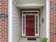 A close up view of the front door with brick surround and visible house number at 10404 Dapping Dr, Raleigh, NC 27614