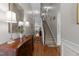Inviting hallway featuring hardwood floors, neutral paint, and an adjacent staircase at 10404 Dapping Dr, Raleigh, NC 27614