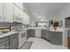 Bright kitchen features two-tone cabinets, stainless steel appliances, and modern countertops at 10404 Dapping Dr, Raleigh, NC 27614