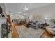 Open-concept living room with a fireplace and hardwood floors at 10404 Dapping Dr, Raleigh, NC 27614