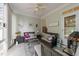 A cozy sunroom with comfortable seating, ceiling fan, and neutral colors at 10404 Dapping Dr, Raleigh, NC 27614