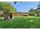 Backyard featuring a deck, patio with Adirondack chairs, and a lush lawn at 105 Choyce Ct, Garner, NC 27529