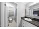 Bright bathroom with a toilet, shelves, and single vanity with granite countertops at 105 Choyce Ct, Garner, NC 27529