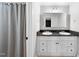 Bathroom featuring a double sink vanity with modern fixtures and a shower with curtain at 105 Choyce Ct, Garner, NC 27529