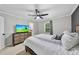 Inviting bedroom features an entertainment center, a ceiling fan, and a window at 105 Choyce Ct, Garner, NC 27529