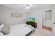 Well-lit bedroom featuring a full bed, ceiling fan, and convenient closet access at 105 Choyce Ct, Garner, NC 27529