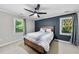 Comfortable bedroom with a striking accent wall, ceiling fan, and bright windows at 105 Choyce Ct, Garner, NC 27529