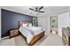 Well-lit bedroom showcasing a full bed, modern ceiling fan, and convenient closet access at 105 Choyce Ct, Garner, NC 27529