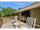 Relaxing deck with wooden railing, sliding glass door to the home, and classic white rocking chairs at 105 Choyce Ct, Garner, NC 27529