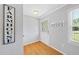 Bright entryway featuring hardwood floors, coat rack, and decorative wall art at 105 Choyce Ct, Garner, NC 27529