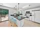 Bright kitchen with white cabinetry, black countertops, and barstool seating at the island at 105 Choyce Ct, Garner, NC 27529