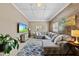Comfortable living room with large sectional sofa, rug, television, and natural lighting at 105 Choyce Ct, Garner, NC 27529