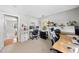 This home office features two workstations, shelving, natural light, and neutral paint at 105 Choyce Ct, Garner, NC 27529