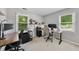 Bright office space featuring natural light from two windows, two desks, and neutral walls at 105 Choyce Ct, Garner, NC 27529