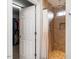 Tiled walk-in shower with a shower curtain is accessible from an open door to the walk-in closet at 105 Pink Dogwood Ln, Mebane, NC 27302