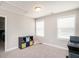 Well-lit bedroom with two windows, a ceiling light, desk, printer, filing cabinet, and plush carpet at 105 Pink Dogwood Ln, Mebane, NC 27302