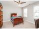 Bright bedroom with neutral walls, plush carpet, two windows, ceiling fan, and a wooden twin-size bed at 105 Pink Dogwood Ln, Mebane, NC 27302