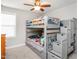 Bedroom with a bunk bed, a storage staircase, plush carpet, white walls, and a ceiling fan at 105 Pink Dogwood Ln, Mebane, NC 27302