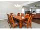Bright dining room open to living room with large wooden table and seating for ten at 105 Pink Dogwood Ln, Mebane, NC 27302