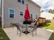 View of the house exterior with a patio, grill, and backyard, perfect for outdoor entertaining at 105 Pink Dogwood Ln, Mebane, NC 27302