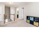 Hallway with carpet, railing, access to multiple rooms, and a storage cubby unit with toys at 105 Pink Dogwood Ln, Mebane, NC 27302