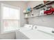 Laundry room with full size washer, dryer, wire racks, and window at 105 Pink Dogwood Ln, Mebane, NC 27302