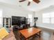 Bright living room featuring a large sectional sofa, flat-screen TV, and plenty of natural light at 105 Pink Dogwood Ln, Mebane, NC 27302