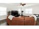 Cozy living room with a large sectional sofa, flat-screen TV, and lots of natural light at 105 Pink Dogwood Ln, Mebane, NC 27302