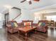 Open-concept living room with comfortable seating, hardwood floors, and lots of natural light at 105 Pink Dogwood Ln, Mebane, NC 27302